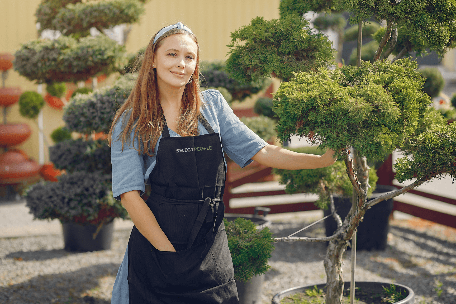 A woman standing with a plant